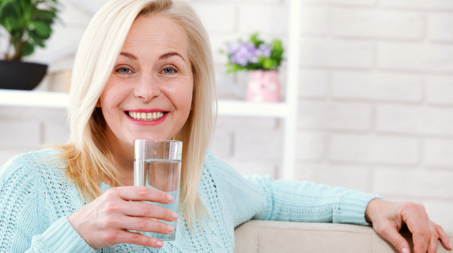 Feature | Beautiful middle aged woman drinking water | Slowing Down the Aging Process with Alkaline Water